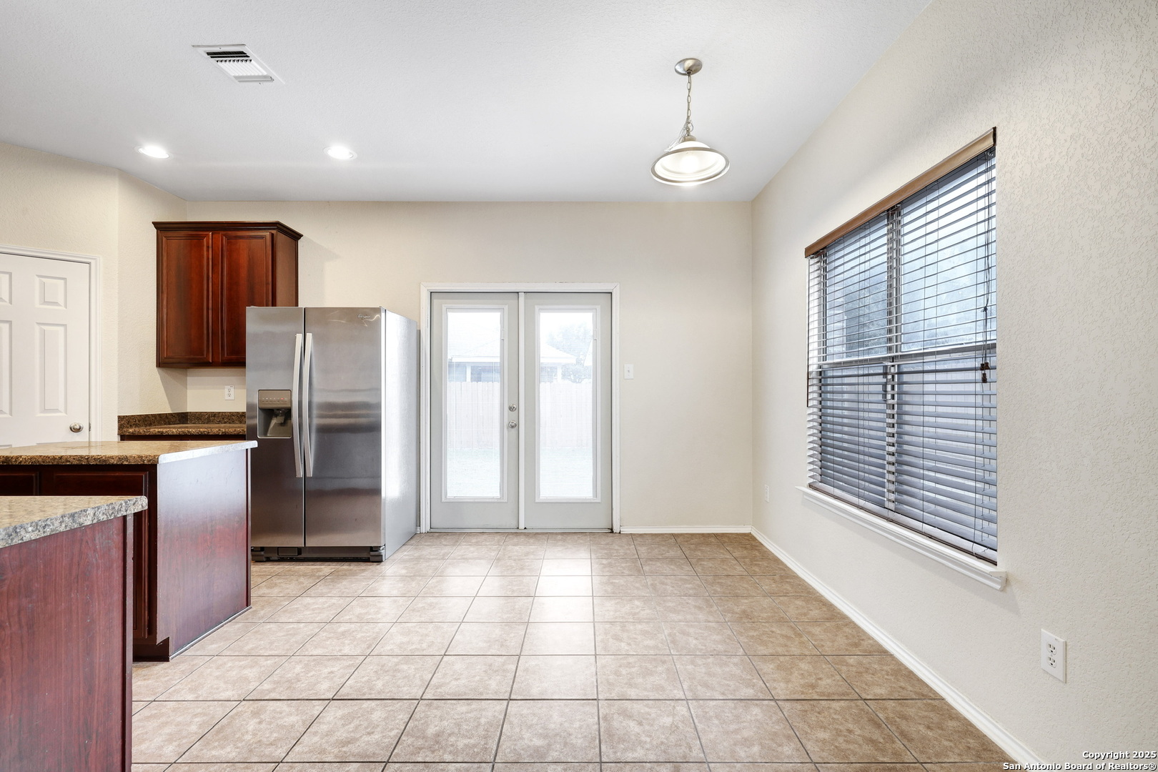 10410 Weser Lane Helotes, TX 78023 - Photo 10 of 22 a view of a kitchen with an empty space and a window