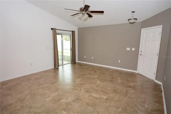 an empty room with a empty space and windows