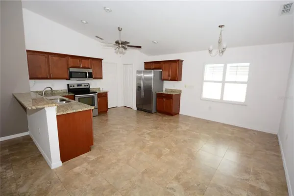 a kitchen with a granite counter top and stainless steel appliances