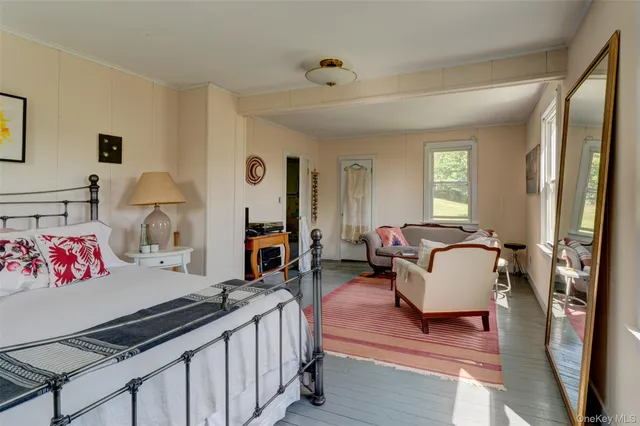 a bedroom with a bed chair and window