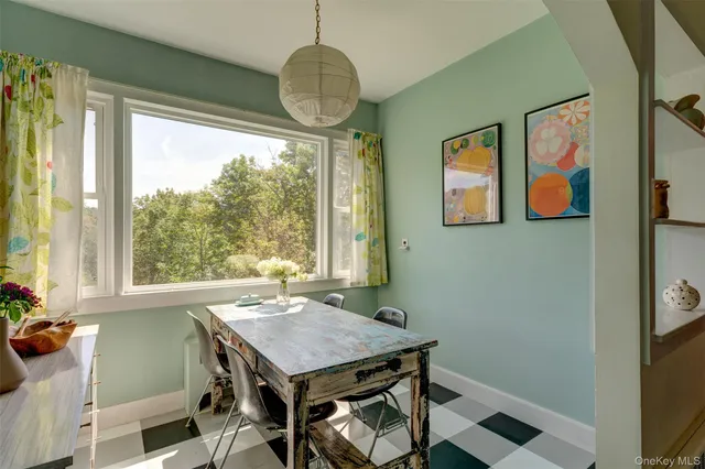 a view of a dining room with furniture wooden floor and a chandelier