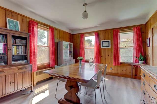 a view of a dining room with furniture and window