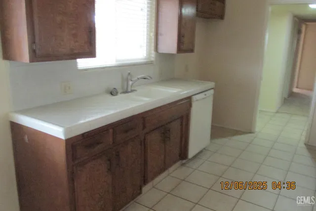 a kitchen with a sink cabinets and a window