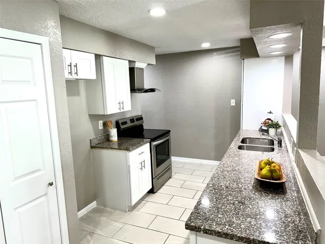 a kitchen with sink a stove and refrigerator