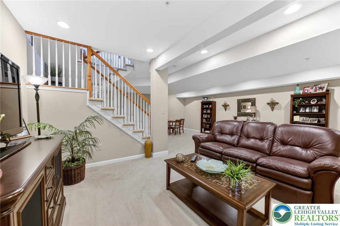 5440 Spring Ridge Drive West Macungie, PA 18062 - Photo 30 of 40 An inviting family room boasts recessed lighting and plush carpet, perfect for comfortable gatherings.