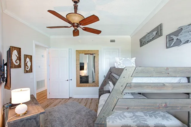 a living room with furniture and a ceiling fan