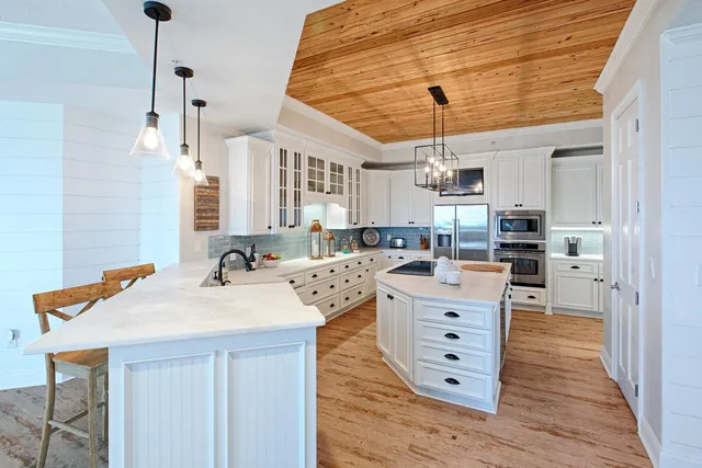 a kitchen with a stove cabinets and wooden floor