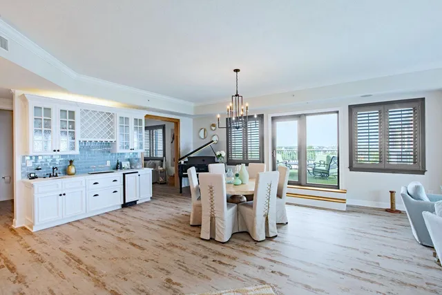 a large white kitchen with chandelier