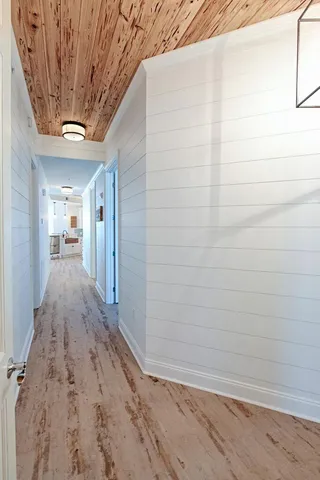 a view of hallway with wooden floor