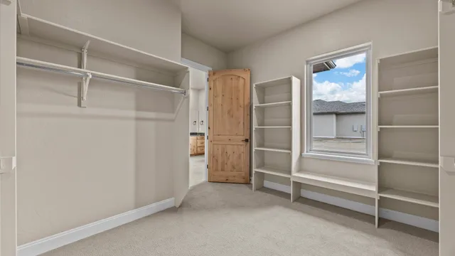 a view of walk in closet with empty racks