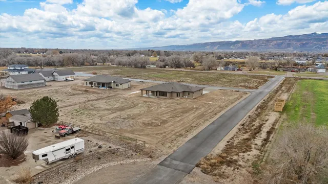 an aerial view of residential houses with outdoor space