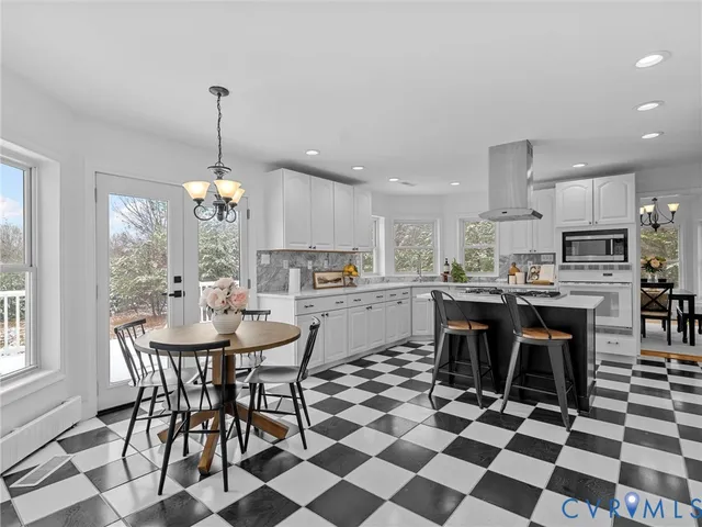 a kitchen with a sink a refrigerator and cabinets