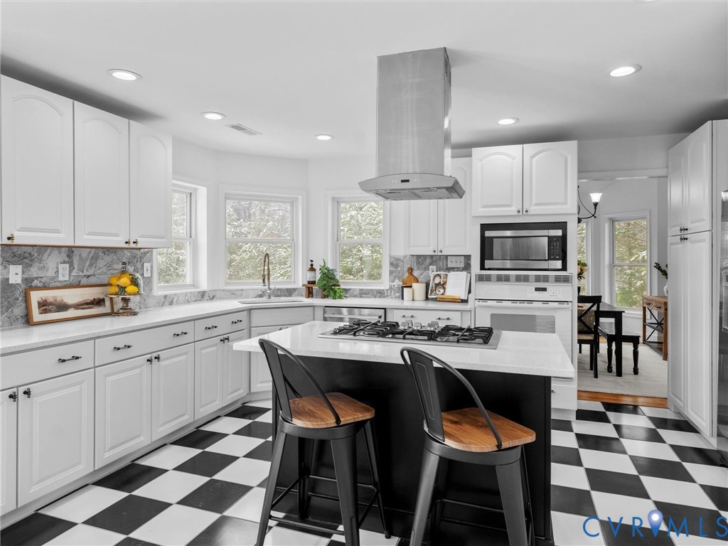 5117 Byrd Mill Road Louisa, VA 23093 - Photo 18 of 50 Kitchen featuring dark flooring, a kitchen bar, wh