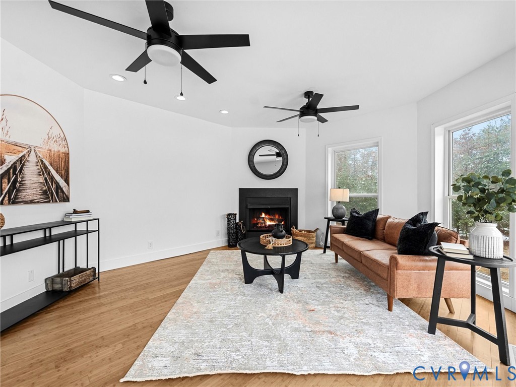 5117 Byrd Mill Road Louisa, VA 23093 - Photo 21 of 50 Living room featuring a lit fireplace, light wood