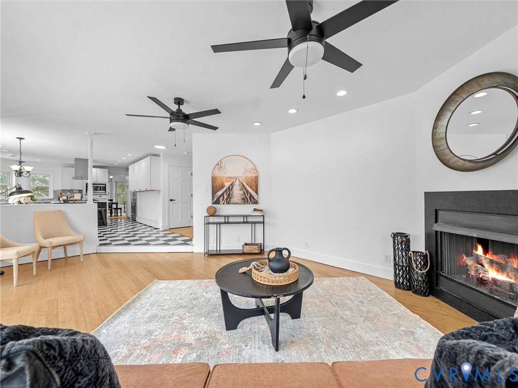 5117 Byrd Mill Road Louisa, VA 23093 - Photo 22 of 50 Living area featuring a lit fireplace, light wood-