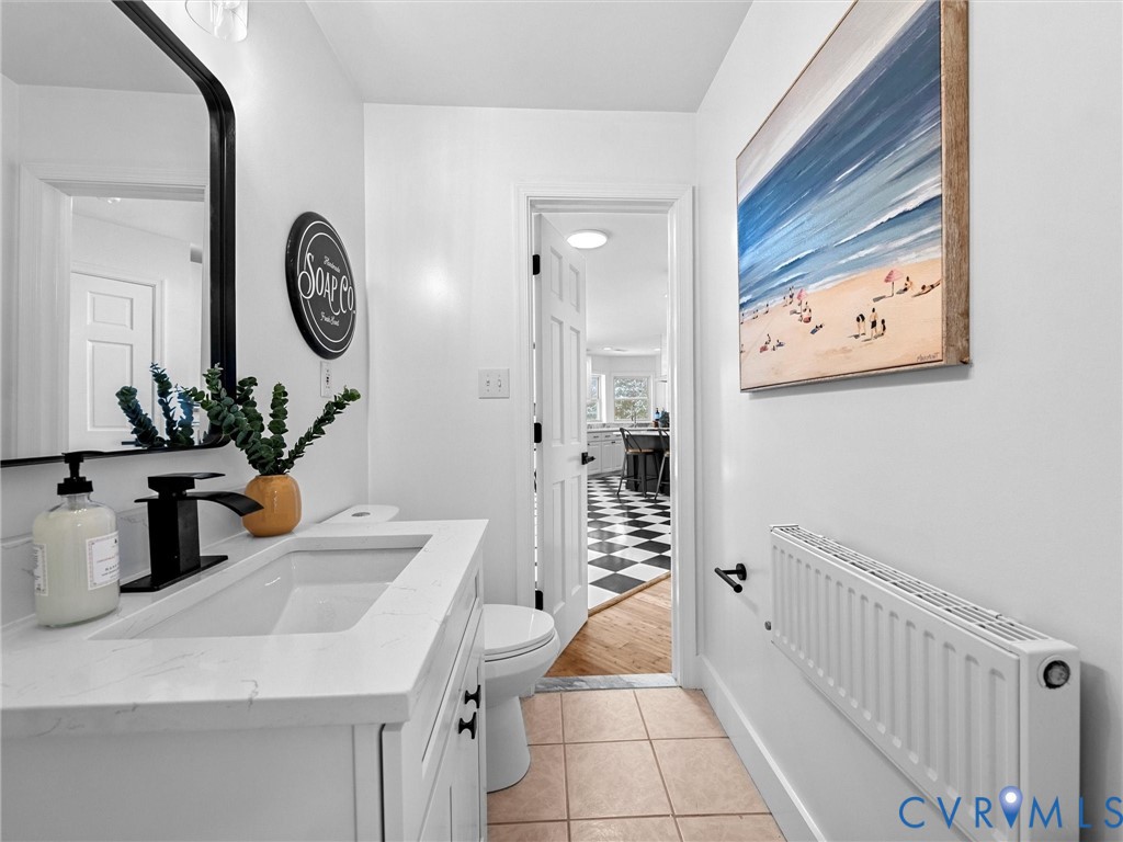 5117 Byrd Mill Road Louisa, VA 23093 - Photo 24 of 50 Bathroom with radiator heating unit, vanity, and l