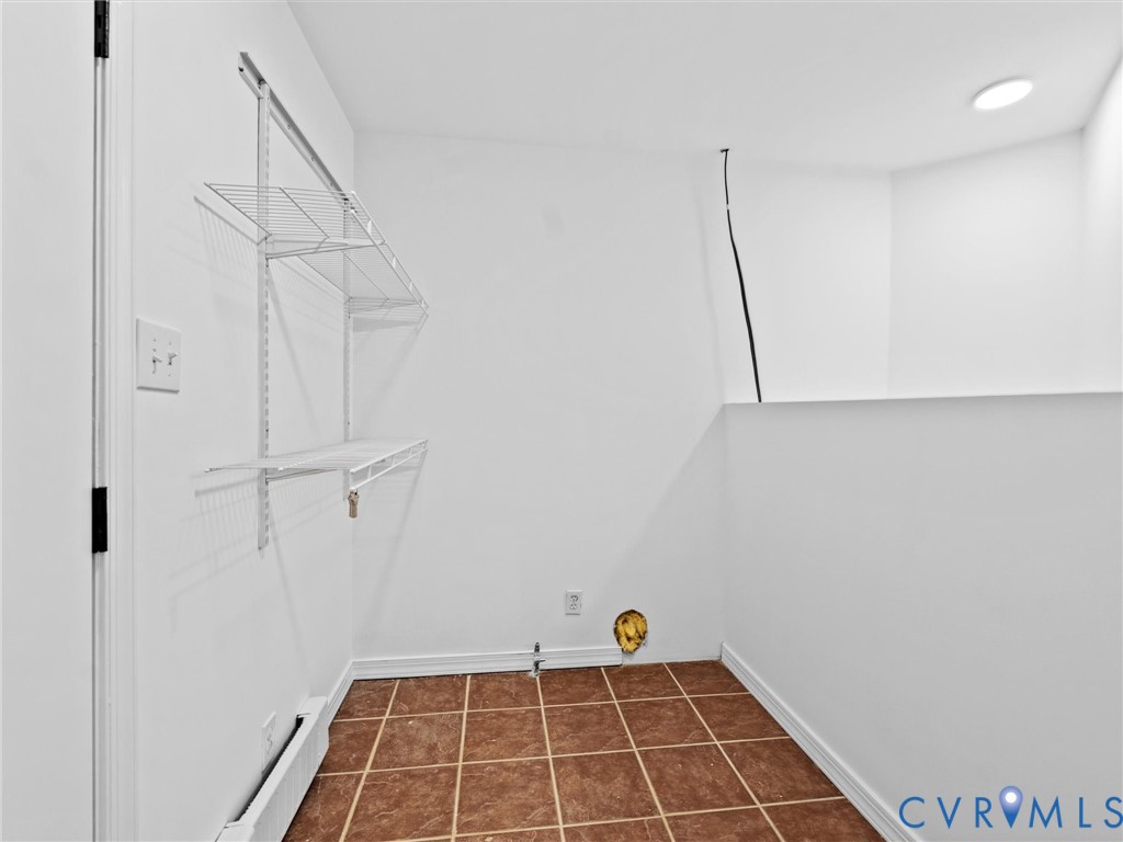 5117 Byrd Mill Road Louisa, VA 23093 - Photo 26 of 50 Washroom with dark tile patterned floors and a bas