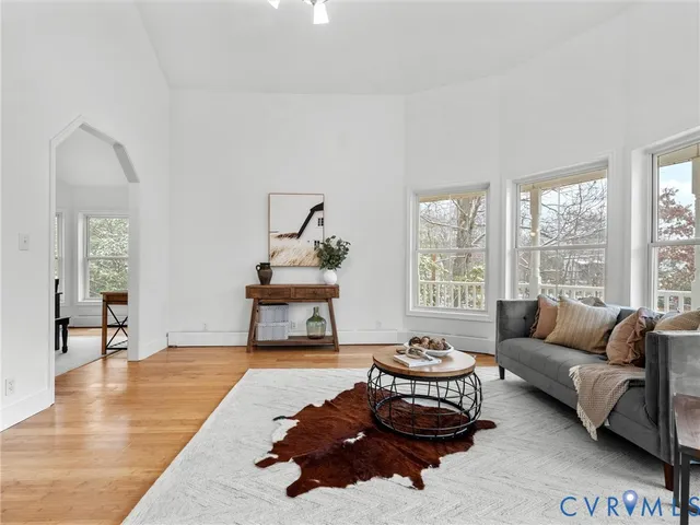 a living room with furniture rug and window