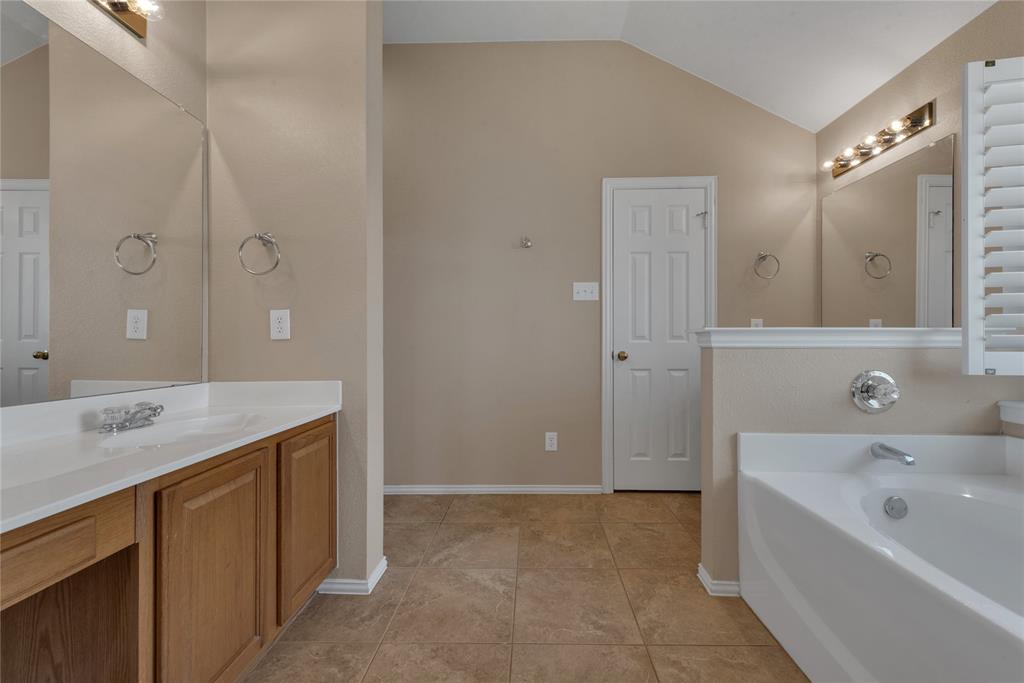 910 Derby Court Celina, TX 75009 - Photo 17 of 27 a bathroom with a tub sink and mirror