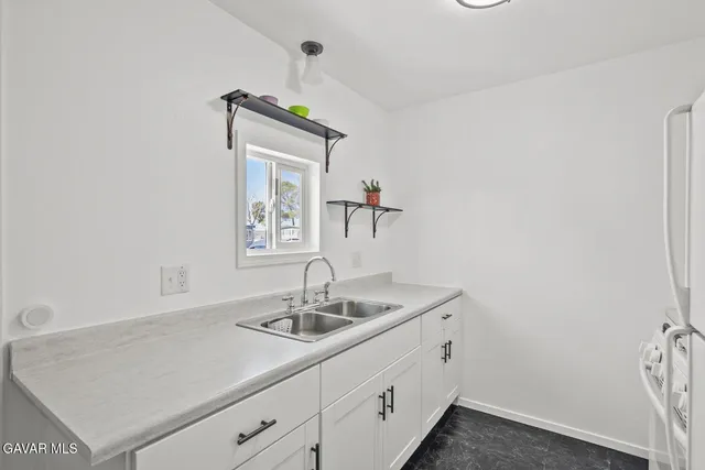 a white refrigerator freezer sitting inside of a kitchen