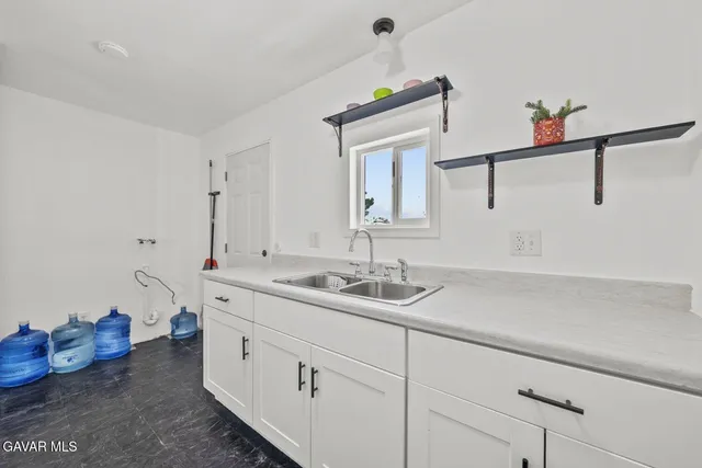 a bathroom with a sink and cabinets