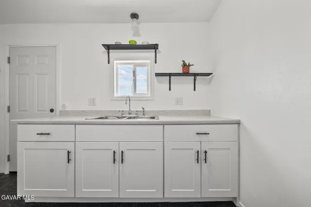 a bathroom with a shower and a sink