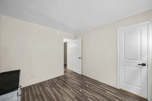 a room with a baby crib and a dresser