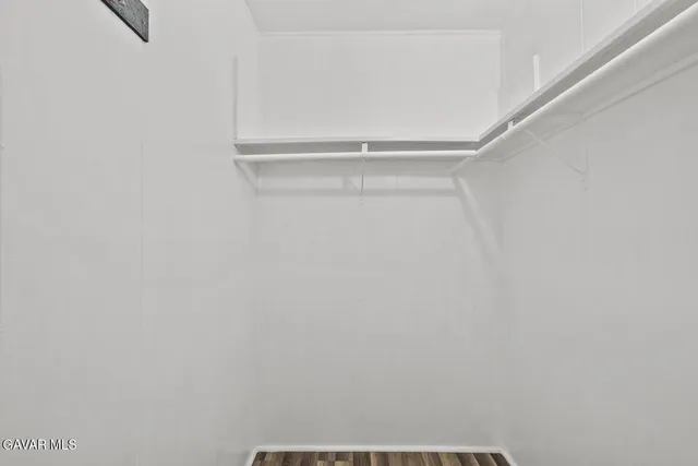 a kitchen with a refrigerator and white cabinets