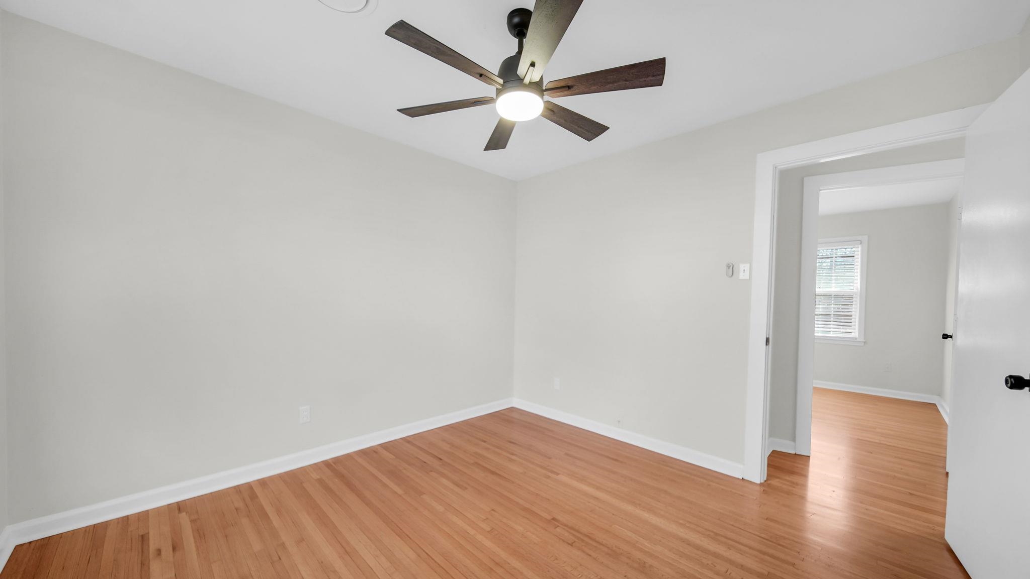2800 Spring Hill Drive Memphis, TN 38127 - Photo 25 of 31 an empty room with wooden floor and a ceiling fan