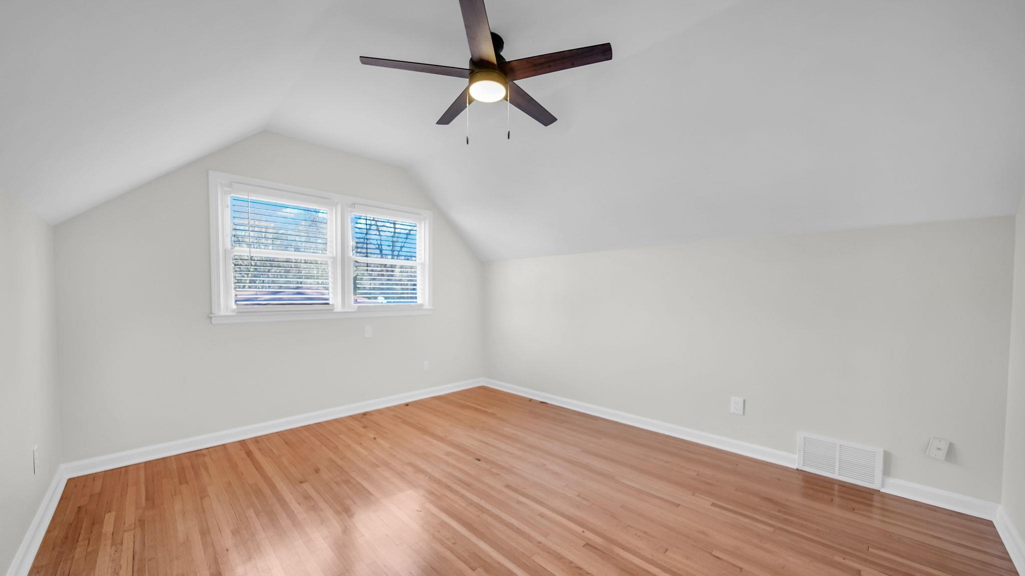 2800 Spring Hill Drive Memphis, TN 38127 - Photo 29 of 31 an empty room with wooden floor ceiling fan and windows