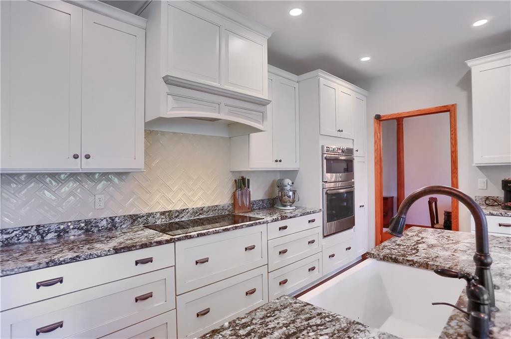 110 Larkspur Circle Butler, PA 16002 - Photo 13 of 50 Abundant custom cabinetry, custom tile back splash that compliments endless counter space, deep farmhouse sink, casual seating and more are highlights of this kitchen.