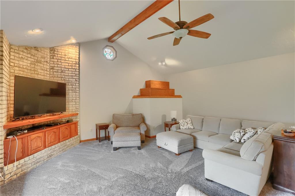 110 Larkspur Circle Butler, PA 16002 - Photo 21 of 50 Exposed beams complement the wooden media stand and brick accent wall.