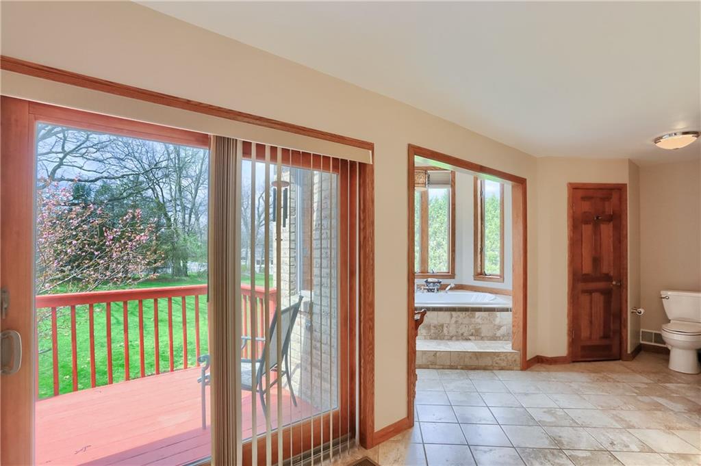 110 Larkspur Circle Butler, PA 16002 - Photo 27 of 50 Wow, this primary bathroom is truly a retreat with a garden tub surrounded by windows, dual sink vanity, shower and a deck for winding down the day.