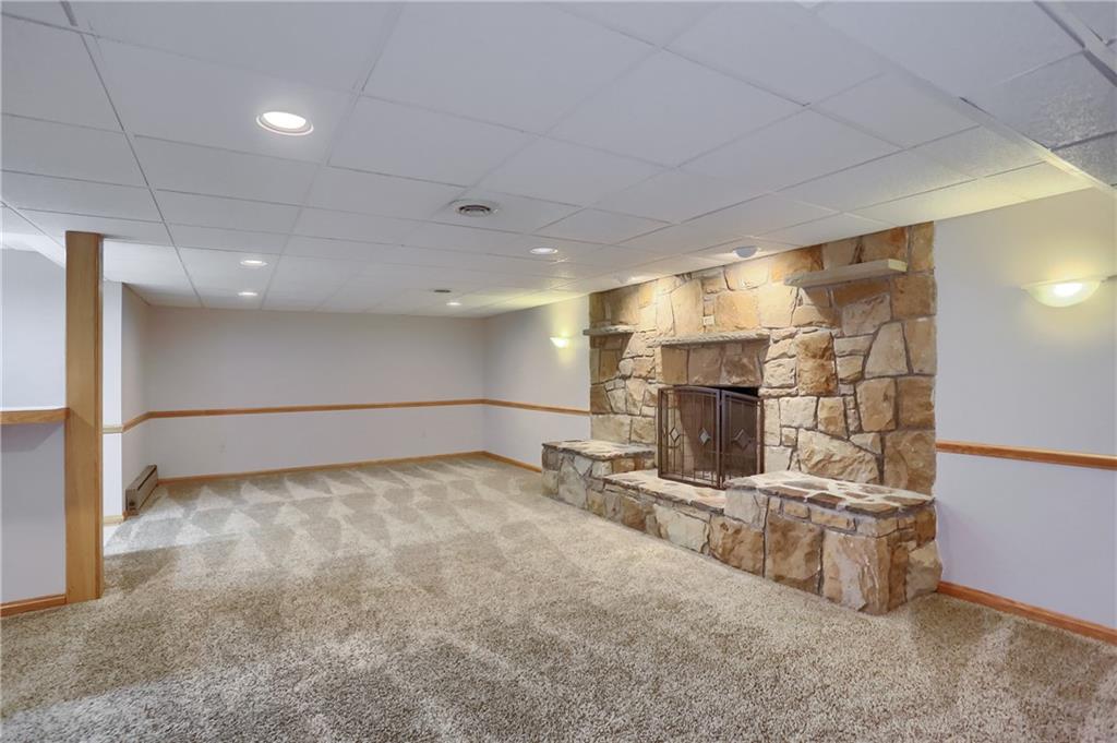 110 Larkspur Circle Butler, PA 16002 - Photo 37 of 50 The finished lower level features this stone fireplace adjacent to the bar area. Friends and family will enjoy gathering around this space at your next party.