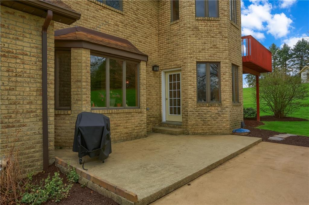 110 Larkspur Circle Butler, PA 16002 - Photo 43 of 50 Step outside from the kitchen onto the patio that extends out to a firepit area.