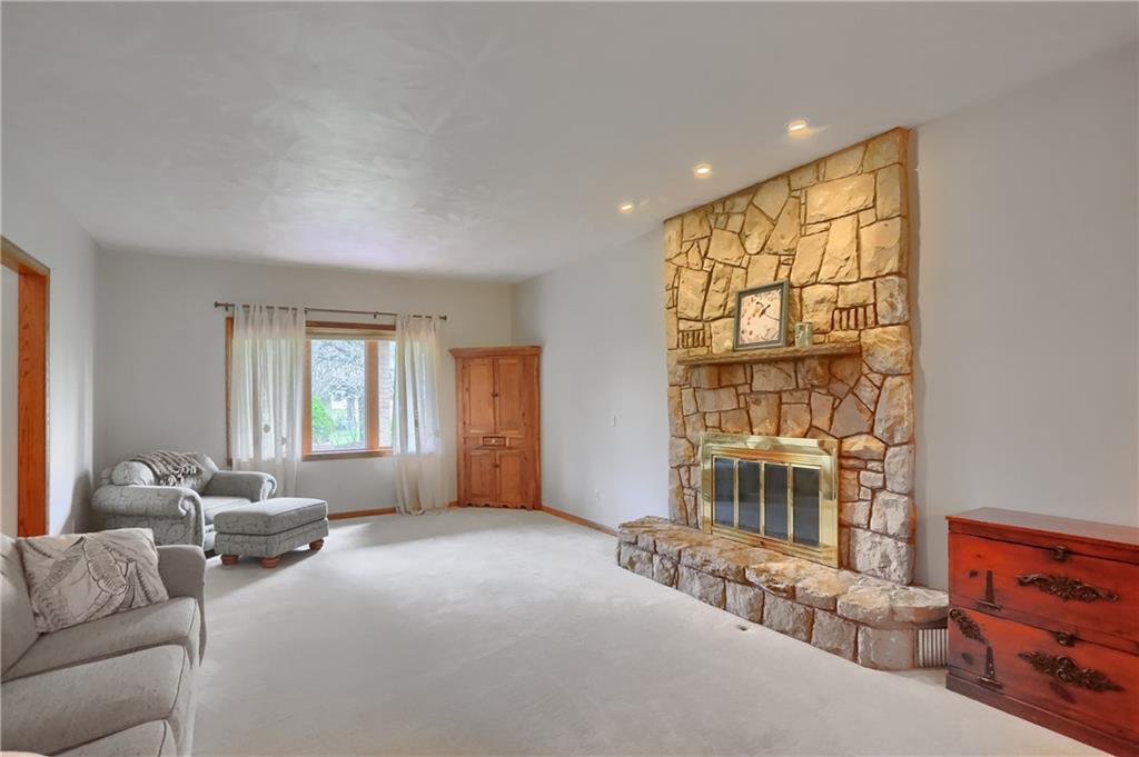 110 Larkspur Circle Butler, PA 16002 - Photo 9 of 50 An expansive living room is adjacent to the foyer and showcases a floor to ceiling stone fireplace, neutral carpeting and tone along with a sunfilled windows.