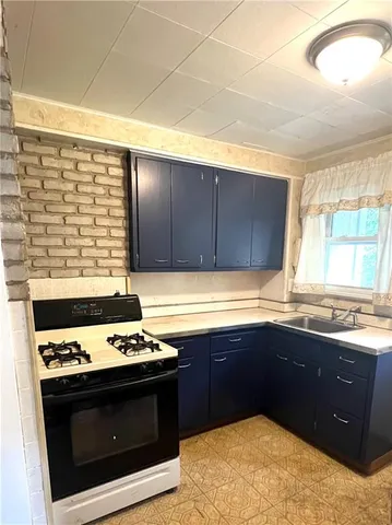 a kitchen with a sink and a stove