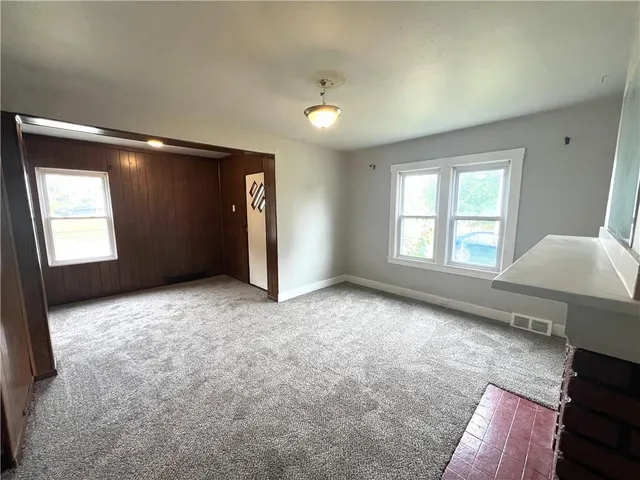 an empty room with windows and closet