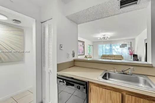 a view of a kitchen with stainless steel appliances granite countertop a sink and a refrigerator