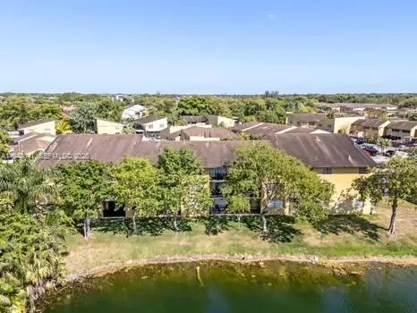 an aerial view of a houses with a lake view
