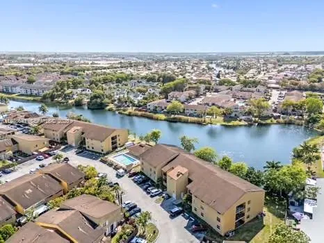 an aerial view of a city with ocean view in back