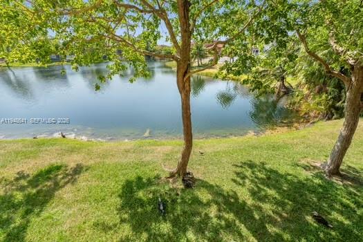 15430 Southwest 82nd Lane, Unit 625 Miami, FL 33193 - Photo 3 of 36 a view of a lake with a yard