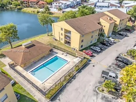 an aerial view of a house with a garden and lake view