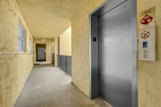 a view of a hallway with wooden shelves