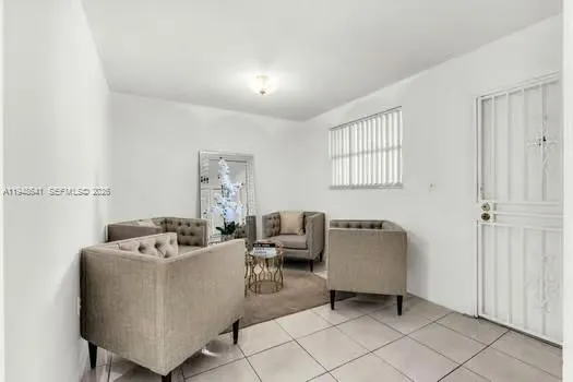 a living room with furniture and a window
