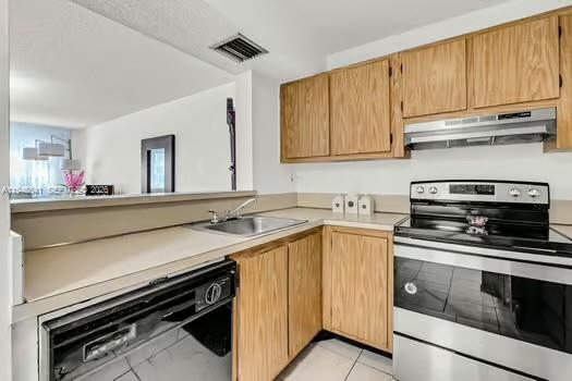 15430 Southwest 82nd Lane, Unit 625 Miami, FL 33193 - Photo 10 of 36 a kitchen with a stove and a sink