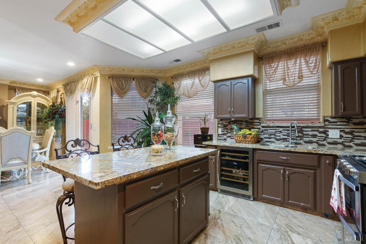 960 Vista Place Lemoore, CA 93245 - Photo 16 of 34 a kitchen with a sink stove and cabinets