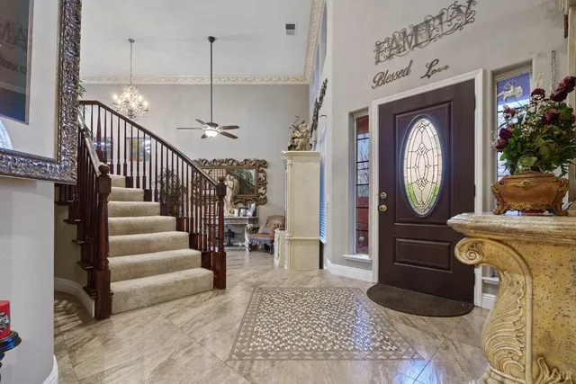 a view of a hallway with entryway wooden floor and a chandelier