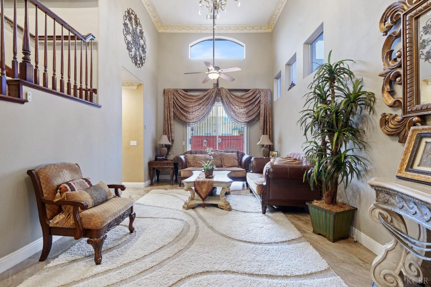 960 Vista Place Lemoore, CA 93245 - Photo 6 of 34 a living room with furniture a chandelier and a rug