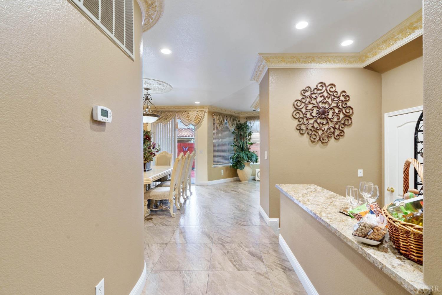 960 Vista Place Lemoore, CA 93245 - Photo 9 of 34 a hallway with beautiful frames and flower vase